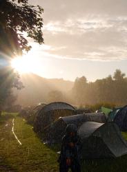 Sun and rain in a field of tents