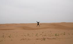 Andrew jumping on a sand dune