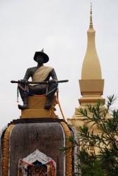 A statue in front of Wat Pha That Luang