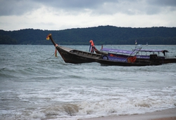 Boats on rough seas as rain comes in